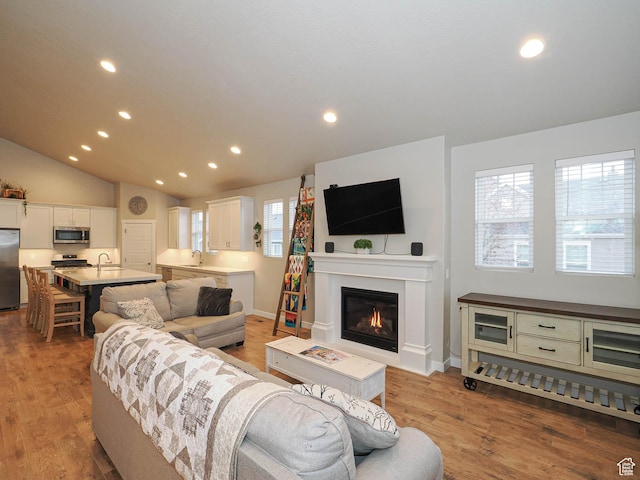 living area with recessed lighting and light wood-type flooring