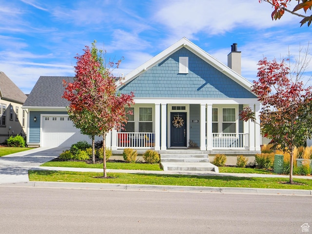 view of front of property featuring covered porch and a garage