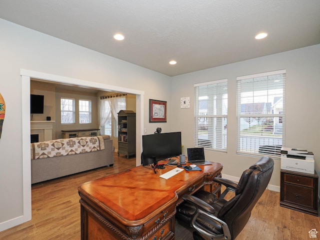 office space with recessed lighting, light wood finished floors, and baseboards