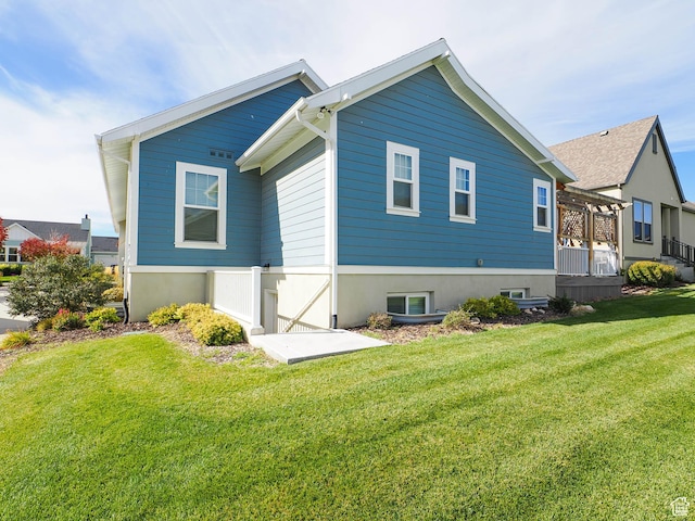rear view of property featuring a lawn