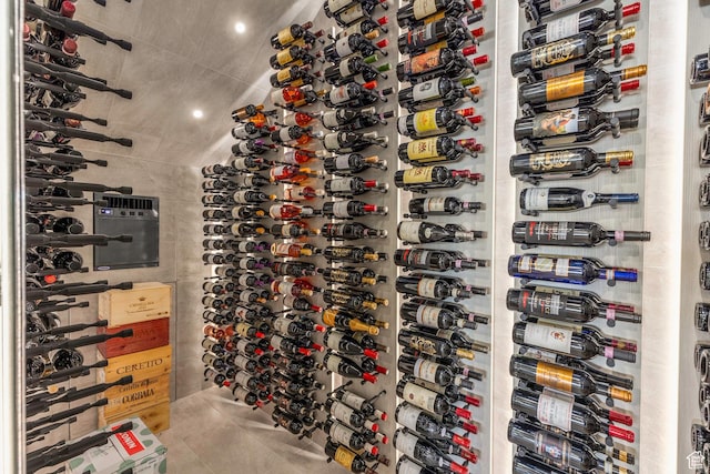 wine area featuring tile patterned floors and recessed lighting