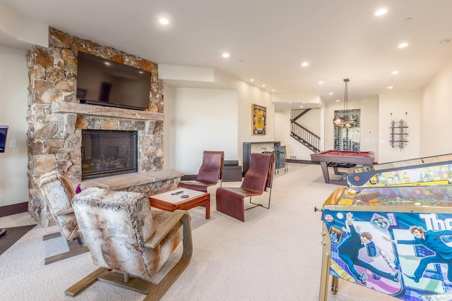 living area with pool table, a stone fireplace, recessed lighting, carpet floors, and stairs