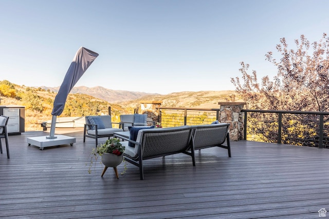 deck with a mountain view and an outdoor hangout area