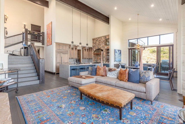 living area featuring an inviting chandelier, recessed lighting, stairway, wood-type flooring, and high vaulted ceiling