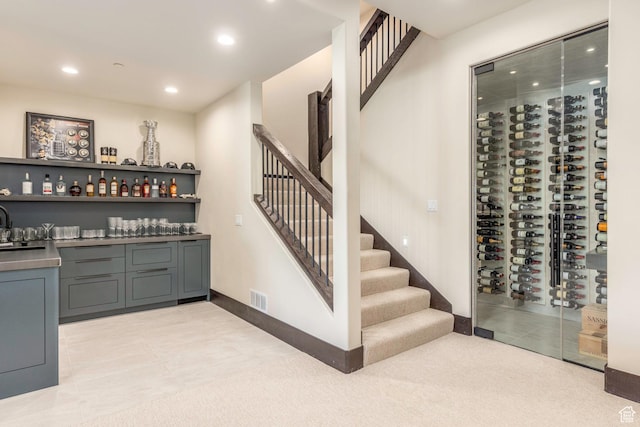 wine room featuring visible vents, baseboards, light tile patterned floors, recessed lighting, and bar