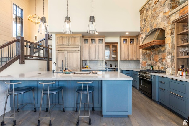 kitchen with custom exhaust hood, dark wood-style flooring, a high ceiling, backsplash, and high end appliances
