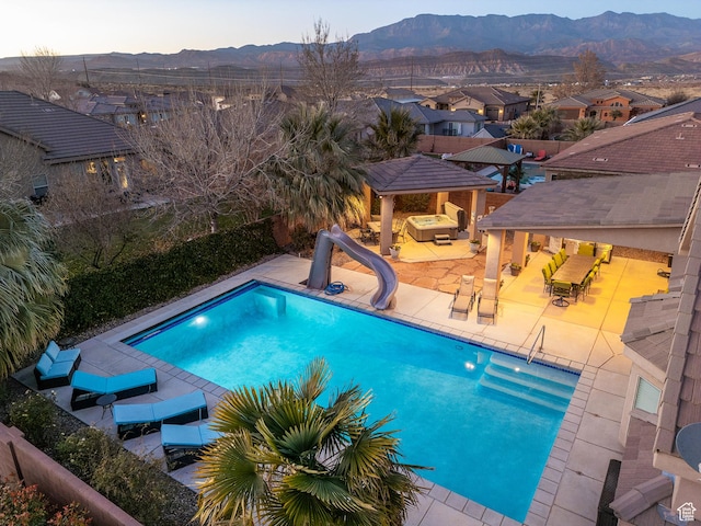 2468 S Dorothy St, Hurricane, UT 84737 - view of swimming pool with a patio area, a mountain view, and a water slide