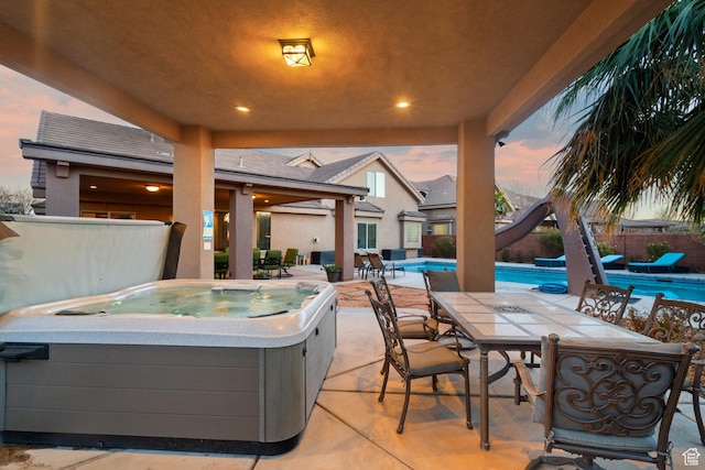 2468 S Dorothy St, Hurricane, UT 84737 - patio terrace at dusk featuring a pool with hot tub
