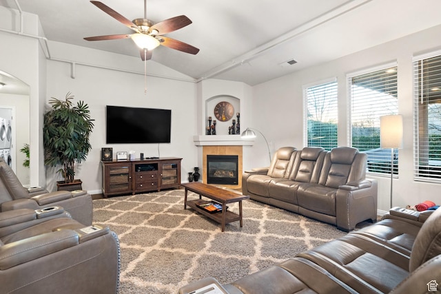 2468 S Dorothy St, Hurricane, UT 84737 - living room with a fireplace, stacked washing maching and dryer, vaulted ceiling, and ceiling fan