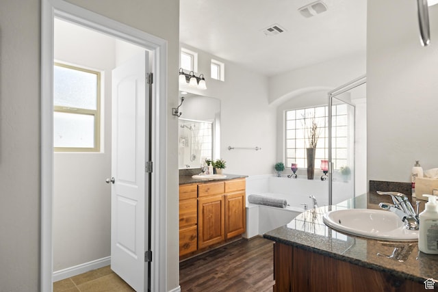 2468 S Dorothy St, Hurricane, UT 84737 - bathroom with vanity, hardwood / wood-style flooring, and a bathing tub
