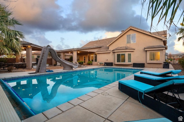 2468 S Dorothy St, Hurricane, UT 84737 - pool at dusk with a patio area and a water slide
