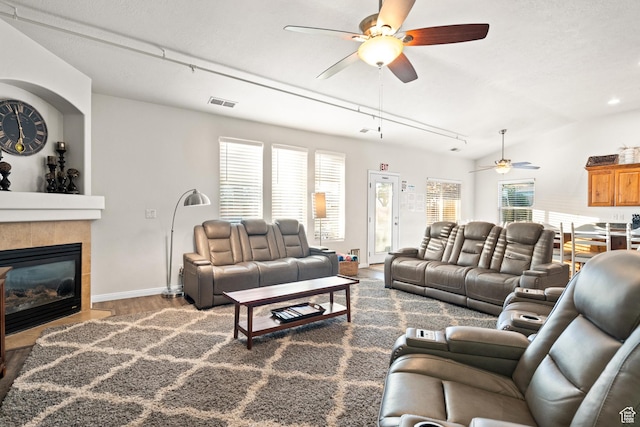 2468 S Dorothy St, Hurricane, UT 84737 - living room with a tile fireplace, hardwood / wood-style flooring, vaulted ceiling, and ceiling fan