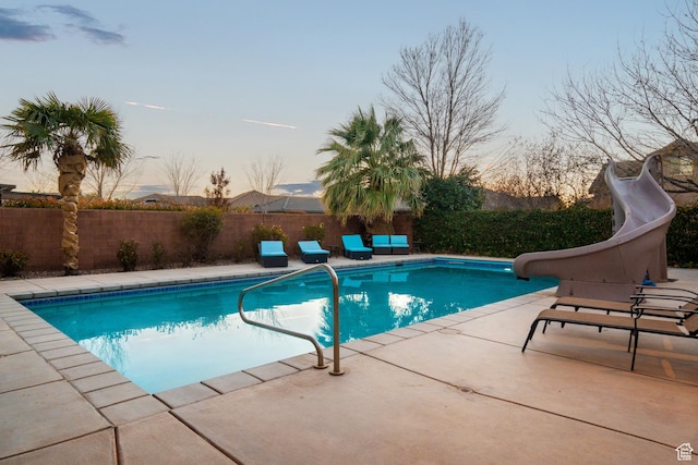 2468 S Dorothy St, Hurricane, UT 84737 - pool at dusk featuring a patio and a water slide