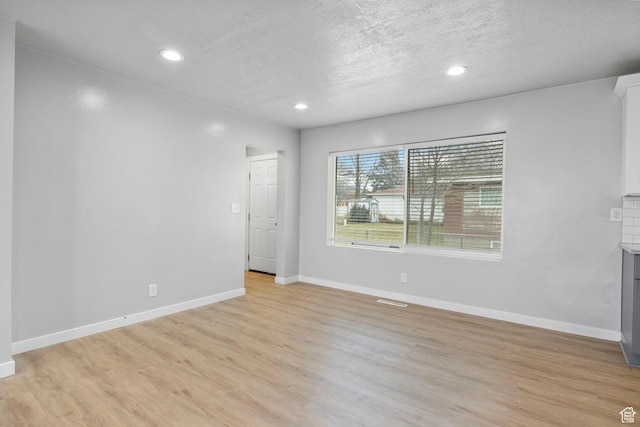 512 N 100 E, Orem, UT 84057 - empty room featuring a fireplace, light hardwood / wood-style flooring, and a textured ceiling