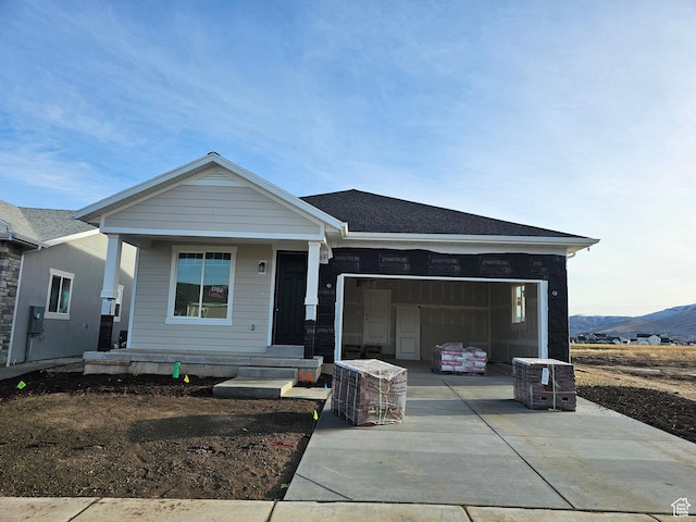 view of front of home featuring a mountain view and a garage