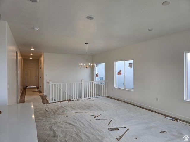 empty room with a notable chandelier