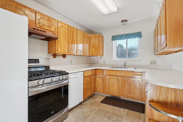 kitchen featuring a textured ceiling, white appliances, extractor fan, and sink