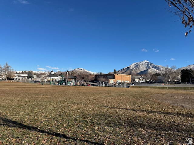 exterior space featuring a mountain view and a lawn