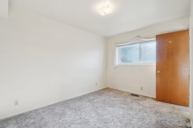 spare room with light carpet