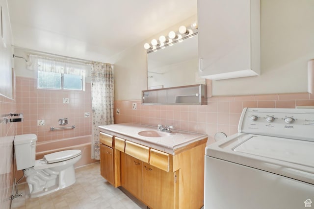 full bathroom featuring vanity, shower / bath combo with shower curtain, tile walls, washer / dryer, and toilet