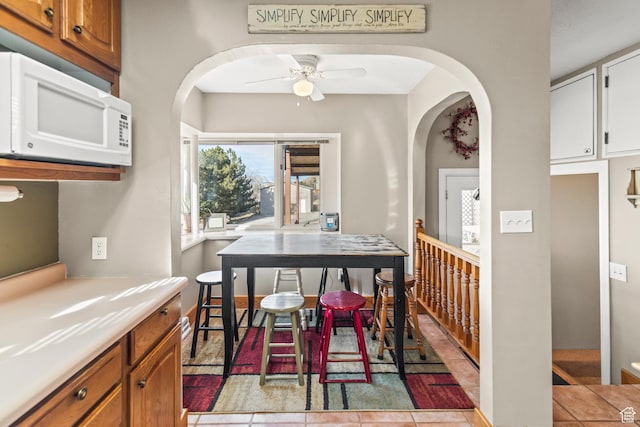 110 N 400 E, Glenwood, UT 84730 - dining space featuring arched walkways, ceiling fan, and baseboards