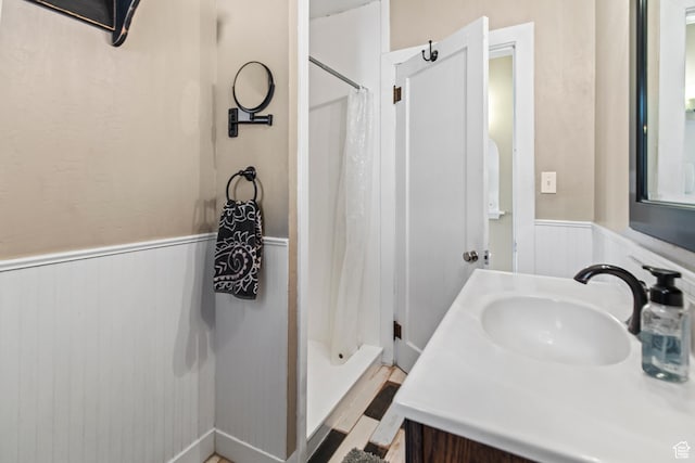 110 N 400 E, Glenwood, UT 84730 - bathroom featuring a wainscoted wall, a shower stall, and vanity