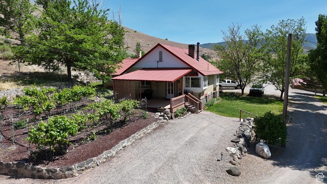 110 N 400 E, Glenwood, UT 84730 - view of front of property with a chimney, a vegetable garden, a mountain view, and metal roof