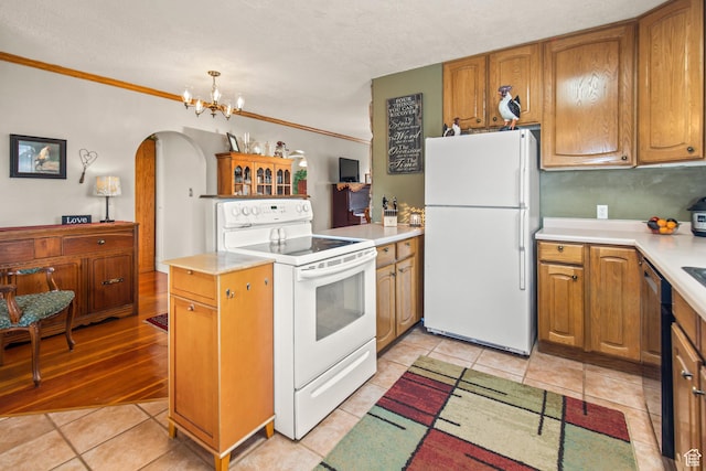 110 N 400 E, Glenwood, UT 84730 - kitchen with white appliances, arched walkways, light countertops, a chandelier, and light tile patterned floors