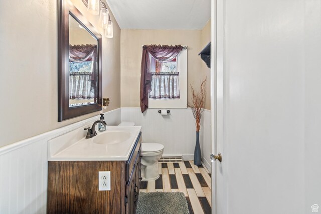 110 N 400 E, Glenwood, UT 84730 - full bathroom featuring a wainscoted wall, vanity, toilet, and wood finished floors