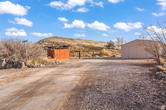110 N 400 E, Glenwood, UT 84730 - view of dirt / gravel driveway featuring a mountain view and a pole building