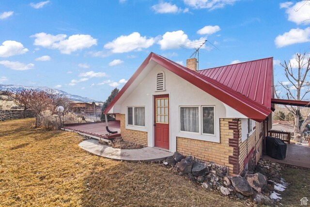 110 N 400 E, Glenwood, UT 84730 - back of property with a deck with mountain view, a chimney, metal roof, and stucco siding