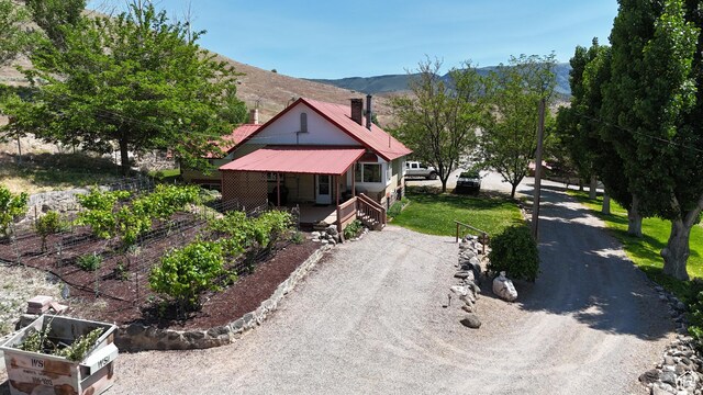 110 N 400 E, Glenwood, UT 84730 - view of front of property featuring covered porch, a chimney, a mountain view, and metal roof