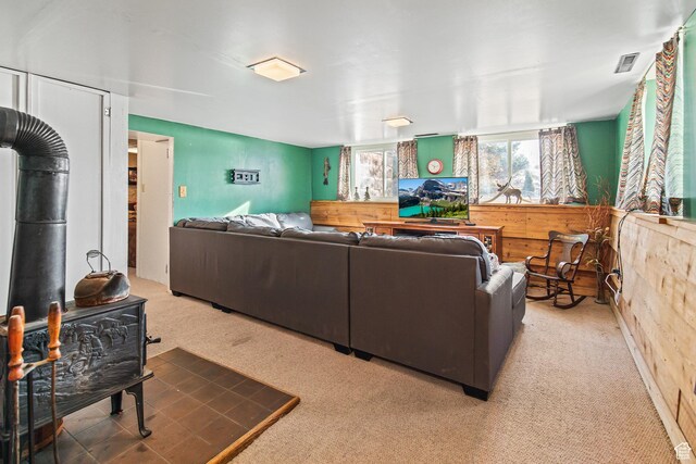110 N 400 E, Glenwood, UT 84730 - carpeted living room with a wood stove and wooden walls