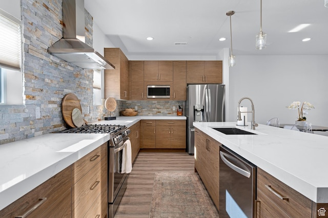 1618 S Main St Unit 3, Salt Lake City, UT 84115 - kitchen featuring sink, decorative light fixtures, appliances with stainless steel finishes, decorative backsplash, and wall chimney range hood
