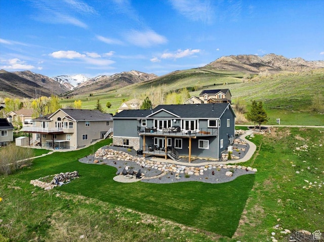 4147 N Wolf Ridge Cir, Eden, UT 84310 - rear view of property with a deck with mountain view and a lawn