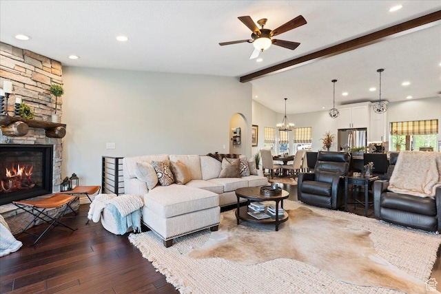 4147 N Wolf Ridge Cir, Eden, UT 84310 - living room featuring ceiling fan with notable chandelier, dark hardwood / wood-style floors, a stone fireplace, and lofted ceiling with beams