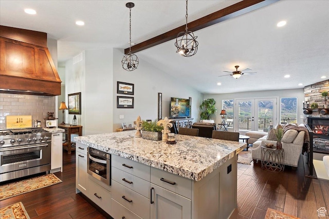 4147 N Wolf Ridge Cir, Eden, UT 84310 - kitchen with a center island, hanging light fixtures, tasteful backsplash, premium range hood, and double oven range