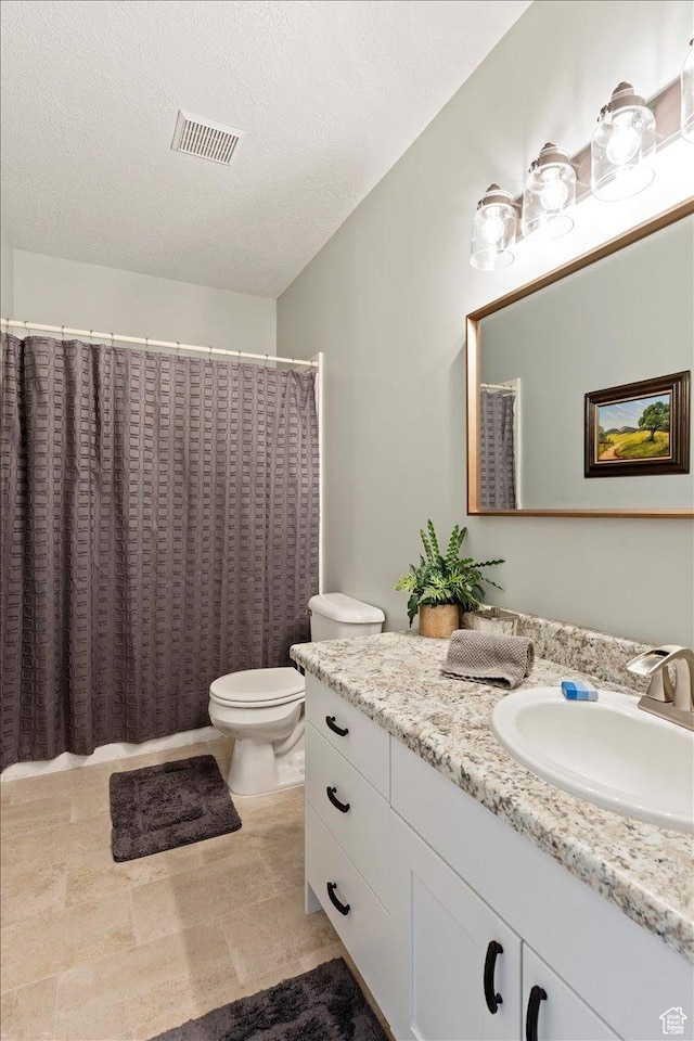 4147 N Wolf Ridge Cir, Eden, UT 84310 - bathroom featuring a textured ceiling, vanity, and toilet