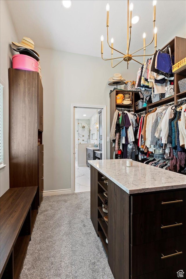 4147 N Wolf Ridge Cir, Eden, UT 84310 - walk in closet featuring light carpet and a chandelier