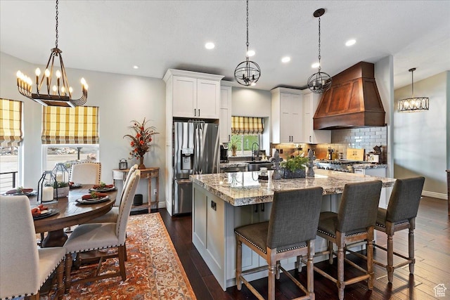 4147 N Wolf Ridge Cir, Eden, UT 84310 - kitchen featuring stainless steel fridge, custom range hood, dark hardwood / wood-style flooring, and white cabinetry