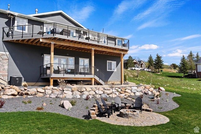 4147 N Wolf Ridge Cir, Eden, UT 84310 - back of house featuring a yard, a fire pit, a deck, cooling unit, and a patio area