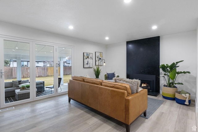 1578 E Delaware Ln S, Holladay, UT 84117 - living room featuring a large fireplace and light hardwood / wood-style floors