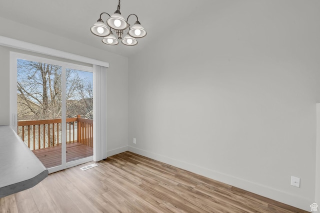 256 Bubbling Brook Ln, Draper, UT 84020 - unfurnished dining area featuring a chandelier and light hardwood / wood-style floors