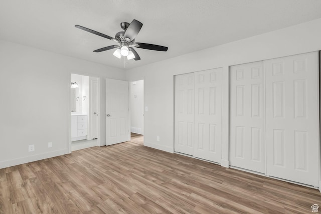 256 Bubbling Brook Ln, Draper, UT 84020 - unfurnished bedroom featuring connected bathroom, light hardwood / wood-style floors, ceiling fan, and multiple closets