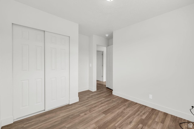 256 Bubbling Brook Ln, Draper, UT 84020 - unfurnished bedroom featuring hardwood / wood-style flooring and a closet