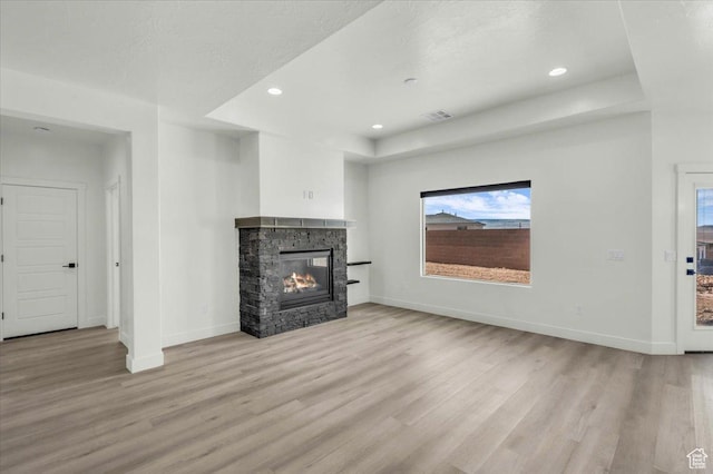 6148 S Square Top Ln, St George, UT 84790 - unfurnished living room with a textured ceiling, light hardwood / wood-style floors, and a fireplace