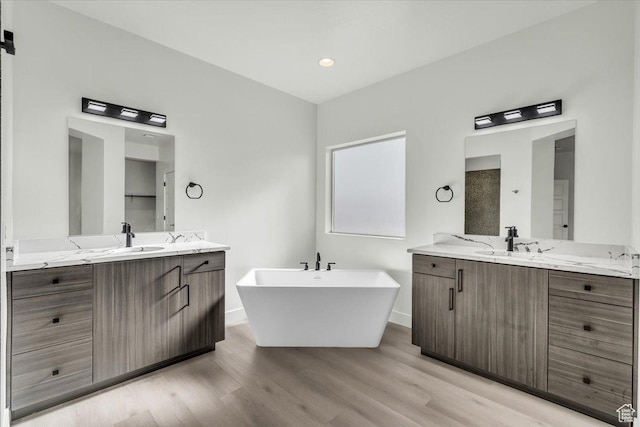 6148 S Square Top Ln, St George, UT 84790 - bathroom with a tub to relax in, vanity, and hardwood / wood-style flooring