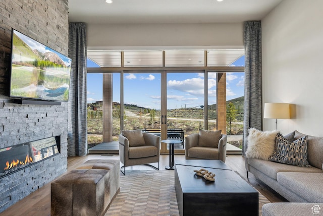 6242 Double Deer Loop, Park City, UT 84098 - living room with a stone fireplace, recessed lighting, and a wall of windows
