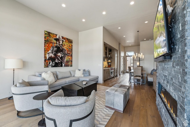 6242 Double Deer Loop, Park City, UT 84098 - living room with wood finished floors, recessed lighting, a glass covered fireplace, and a chandelier