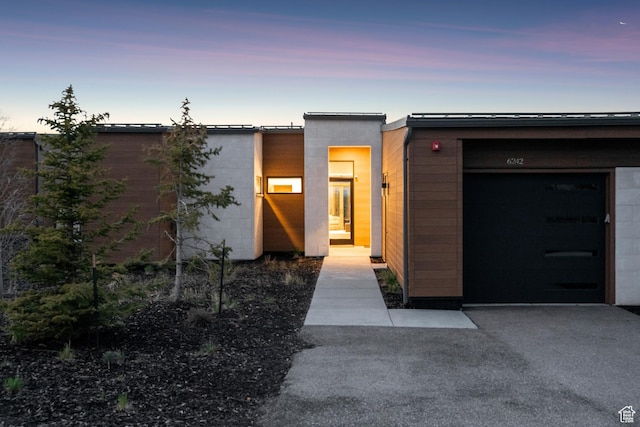 6242 Double Deer Loop, Park City, UT 84098 - exterior entry at dusk with concrete block siding and a garage